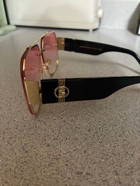 Gucci Black Temple Sunglasses with Pink Gradient Lenses and Gold Accents